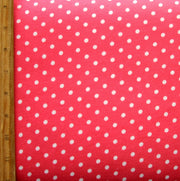 White Eraser Polka Dots on Coral Pink Cotton Knit Fabric